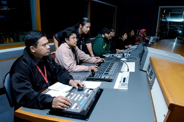 Broadcast control room operators at console managing studio production hardware, illustrating equipment financing success story
